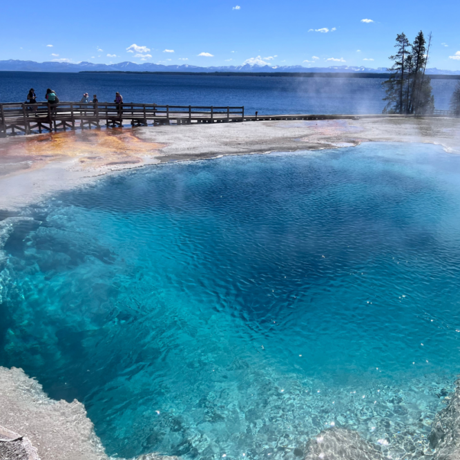 Hot pool at Yellowstone with Yellowstone Lake in the background