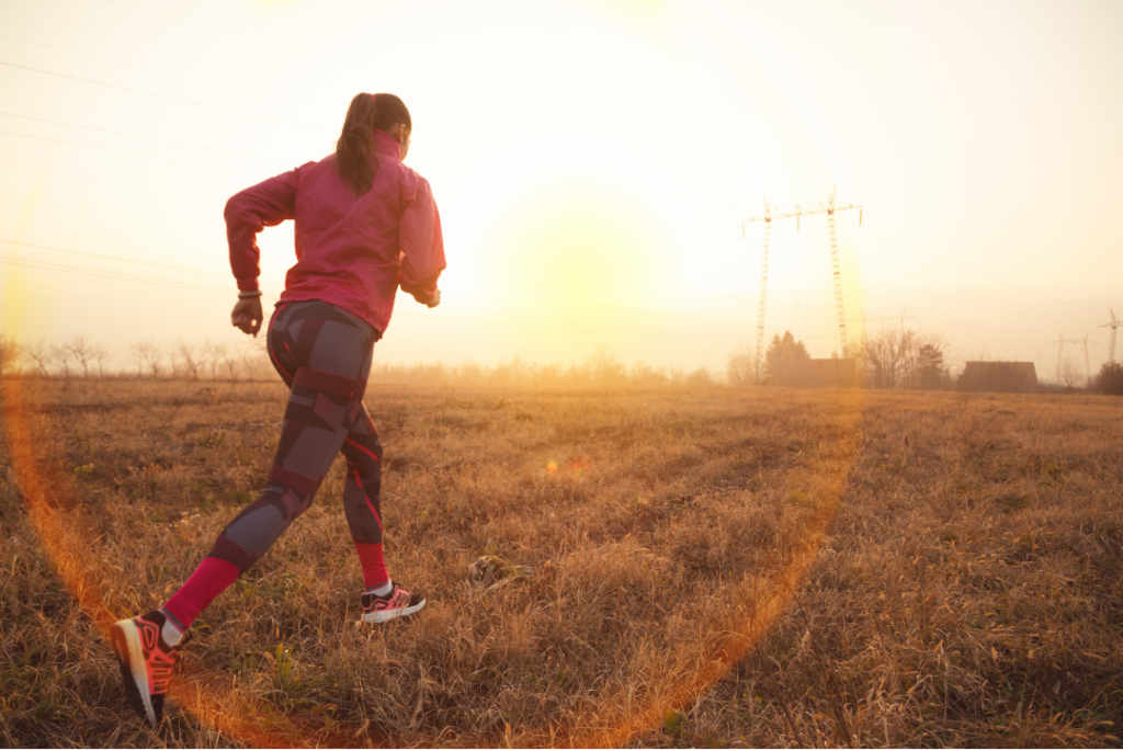 Lady is running towards the sunset